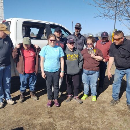 A group of nine people including DV6 to the far-right. The other eight are from the Visions for Creative Housing Solutions from Enfield, New Hampshire.