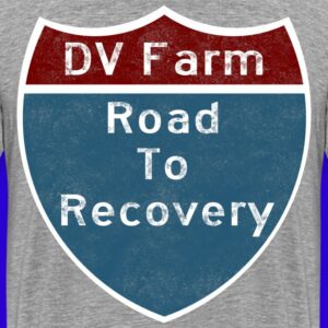 Back decal of t-shirt and merchandise, an interstate sign where the top text with red background reads dv farm and the lower text with blue background reads road to recovery
